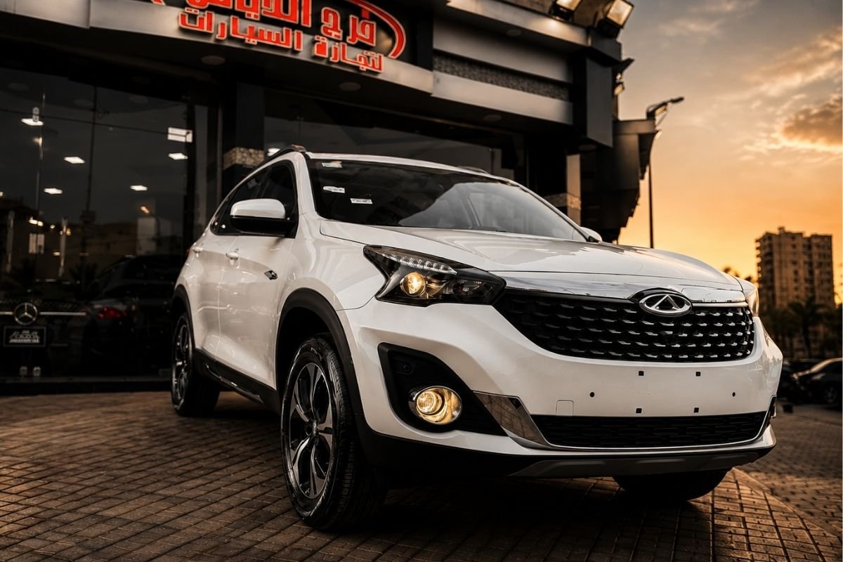 White Chery Tiggo 7 SUV showcased outside dealership during sunset with premium automotive styling.